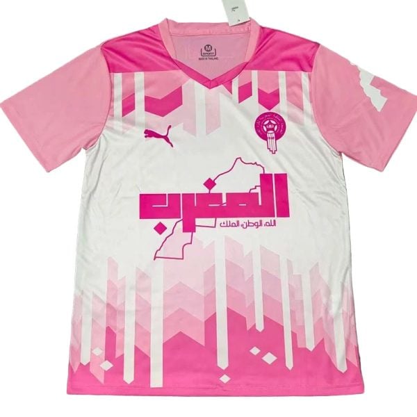 Pink and white soccer jersey featuring a geometric pink pattern, Puma logo, team crest, and Arabic sponsor text.