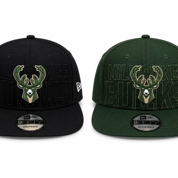 Two Milwaukee Bucks snapback hats, black and dark green, each with an embroidered deer logo and 'BUCKS' lettering on the crown.
