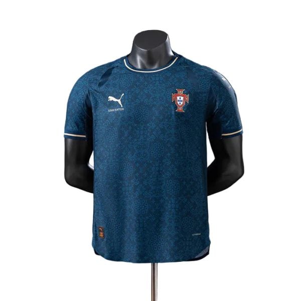 Blue Portugal national team soccer jersey displayed on a mannequin, with crest on the left chest and a white Puma logo on the right.”,
