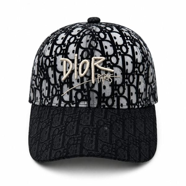 Dior baseball cap in black and gray with a repeating monogram pattern and gold 'DIOR PARIS' embroidery on the front crown.