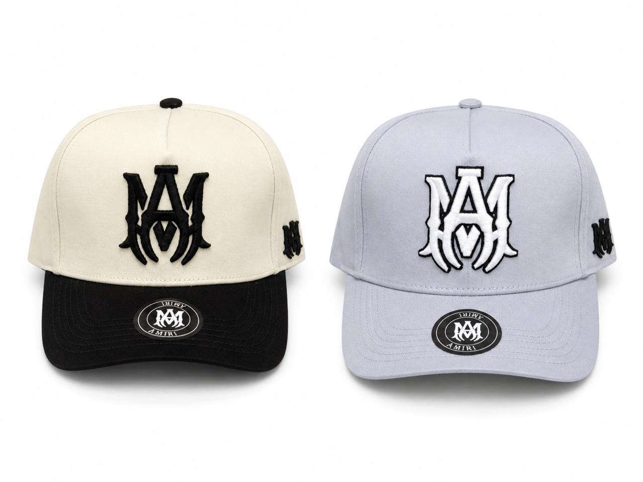 0d17944e-c4ae-4e63-88bc-fea5fa5f9843 | AE JERSEY Two baseball caps displayed side by side: a beige crown with a black brim on the left and a light blue crown with a matching brim on the right, each with a bold M logo on the front and an M on the side panel.