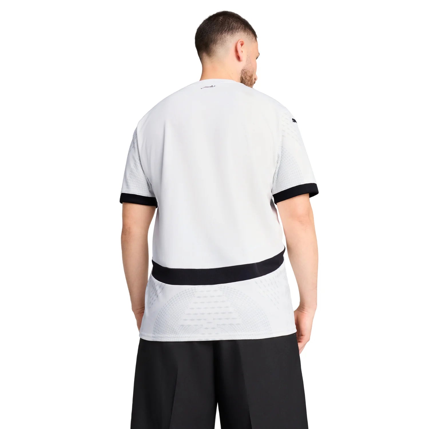 11_55a79fa2-c96b-4cfe-80cc-214af48287be | AE JERSEY Man wearing a white athletic t-shirt with black cuffs and a black waist band, viewed from the back.