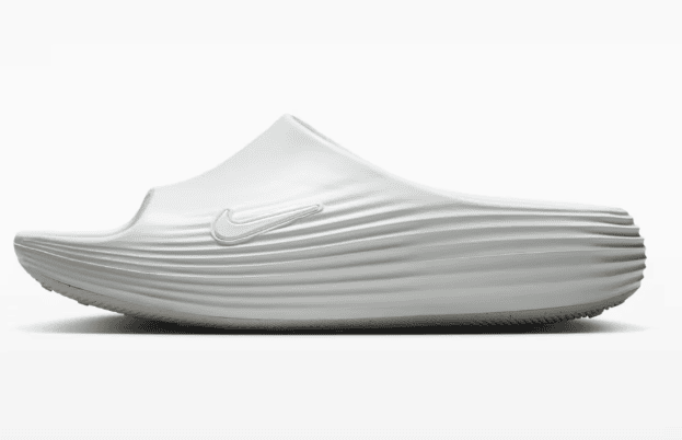 11_fc744175-0a8e-4de1-bb6b-2f78364291a7 | AE JERSEY White slip-on Nike running shoe with a sculpted, ribbed midsole, side view