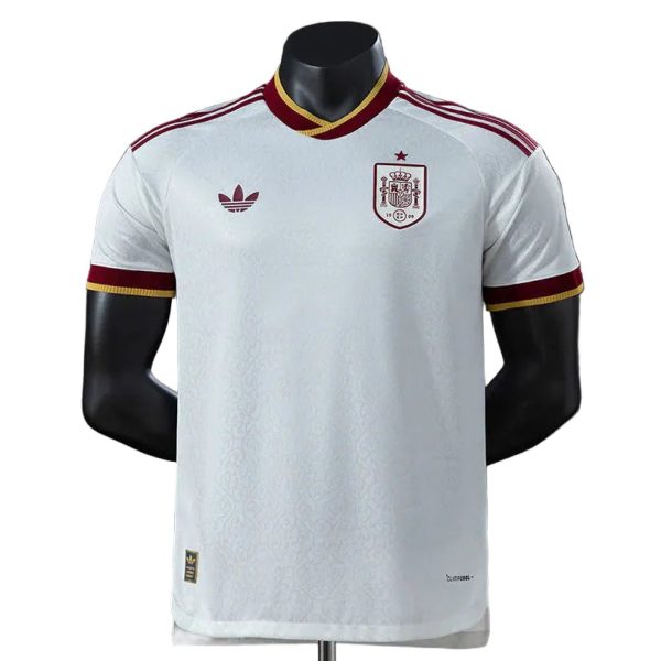 White Spain national football team jersey on a mannequin with burgundy-gold trim and crest on the chest
