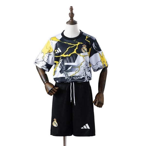 Mannequin dressed in Real Madrid soccer kit: a patterned black, white, and yellow jersey with Real Madrid crest and Adidas logo, paired with black shorts featuring team crest and Adidas logo.