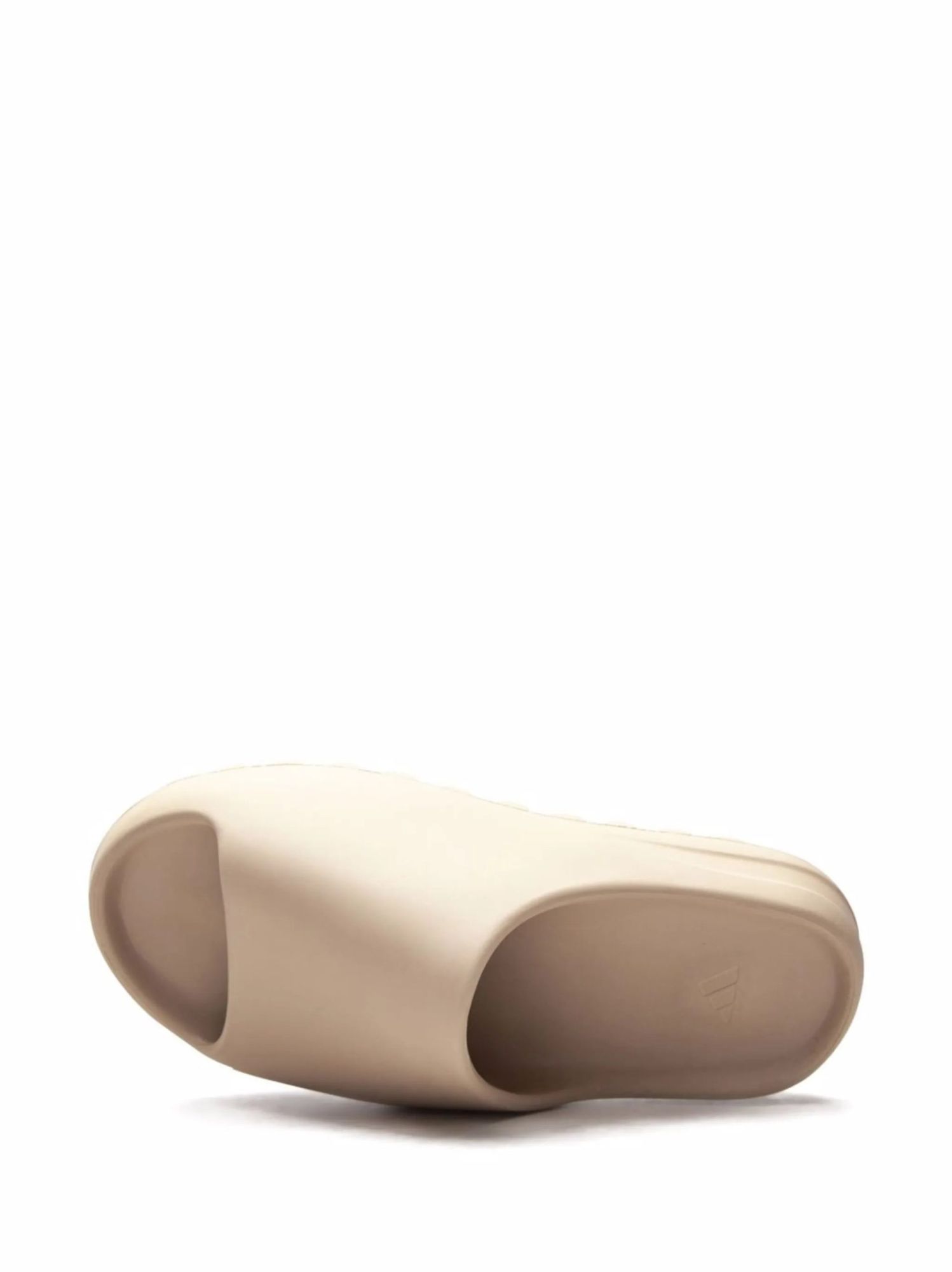 17738013_37286300_2048 | AE JERSEY Beige prosthetic foot shell viewed from the side, showing a curved, hollowed underside and toe area designed to fit a residual limb.