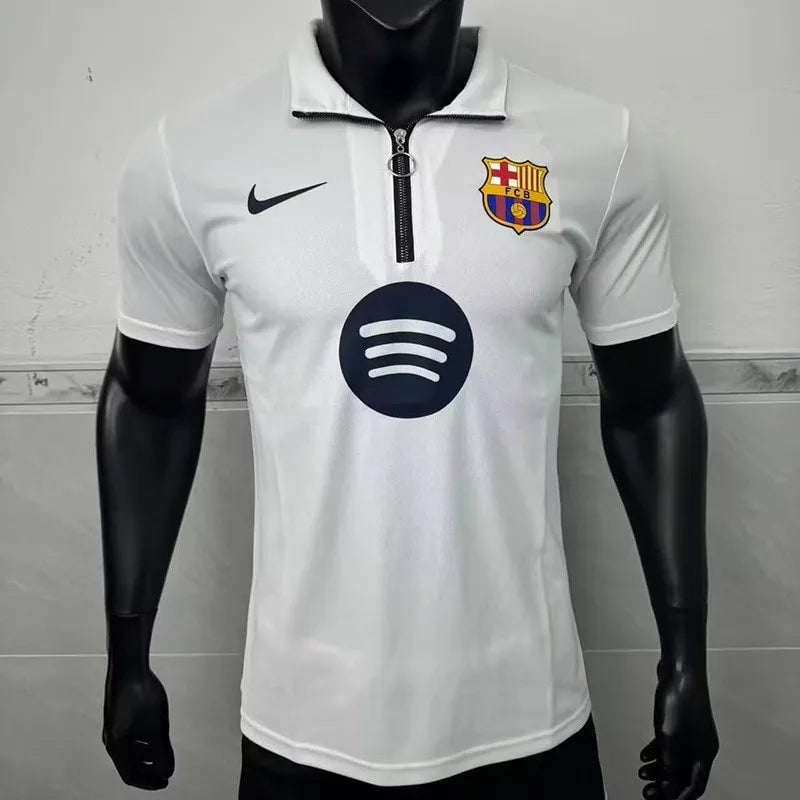 182da9edad2fd1e5 | AE JERSEY White FC Barcelona polo jersey on a black mannequin, with Nike logo on the chest, club crest on the right, and a Spotify sponsor circle in the center.