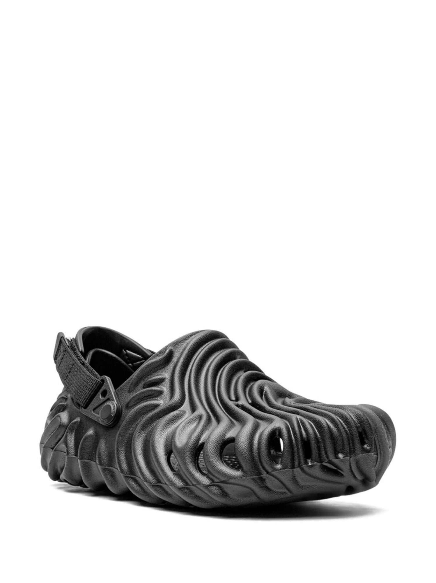 19201488_42050649_2048 | AE JERSEY Close-up of a black athletic sneaker with a thick, wavy-ridged sole and a heel strap detail.