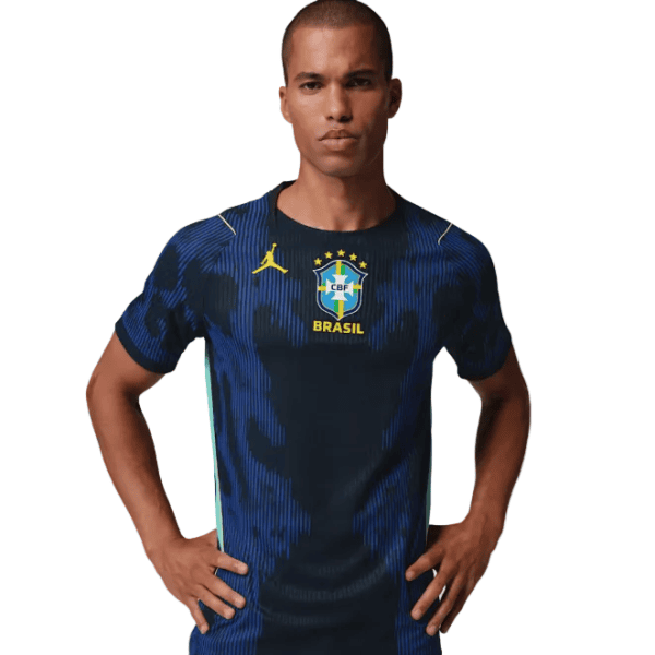 1_5ce0c9a2-f20c-4fe0-b10a-58074717644d | AE JERSEY Male model wearing a dark blue Brazil national team jersey with the CBF crest and a yellow Jumpman logo on the chest.
