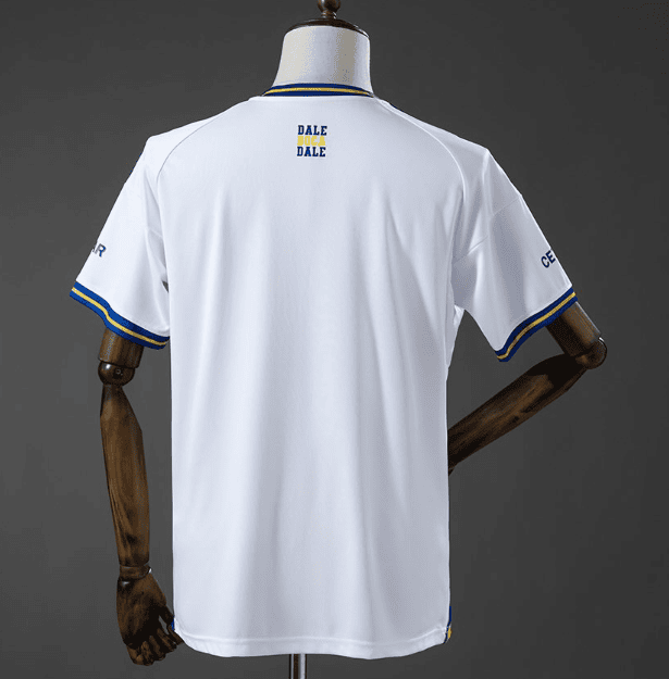 1_d5c05d3a-b6f6-410c-8686-2583018df0d3 | AE JERSEY Back view of a white sports jersey with blue and yellow trim, mannequin displaying small 'DALE DALE' logo on upper back and blue/yellow sleeve cuffs.