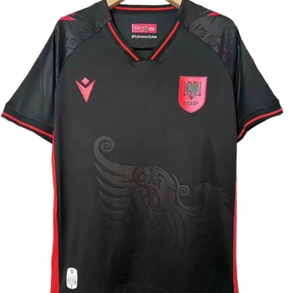 Black soccer jersey on a hanger with red trim and crest, featuring a red shield with a double-headed eagle on the chest.