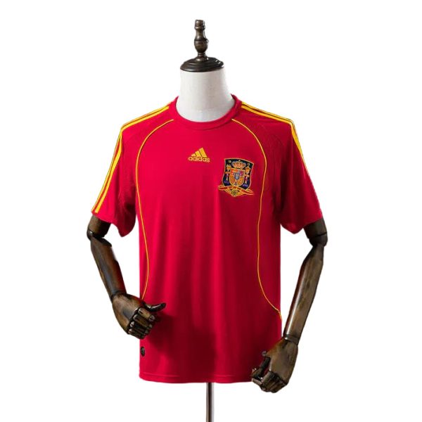 Red Spain national team soccer jersey on a mannequin, with Adidas logo and crest on the chest.