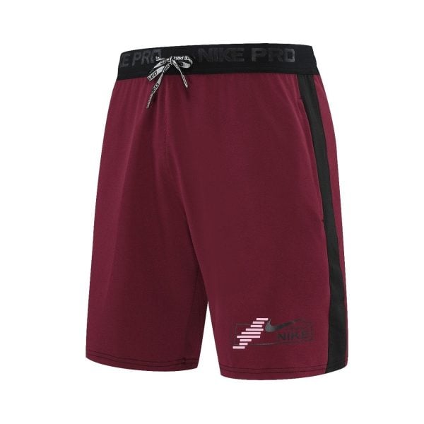 Maroon Nike Pro athletic shorts with a black waistband and a black side stripe, tied with a drawstring, Nike logo on the front left leg.