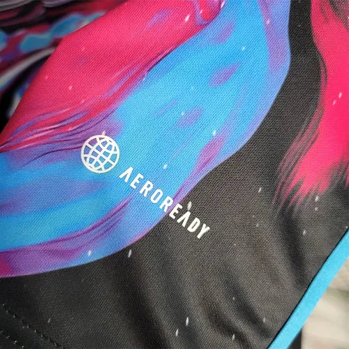 20903b_3fc3504ea8924c599c23b959f78a7c38_mv2 | AE JERSEY Close-up of black fabric with a blue-pink abstract design and the Aeroready logo with a small globe icon near it.