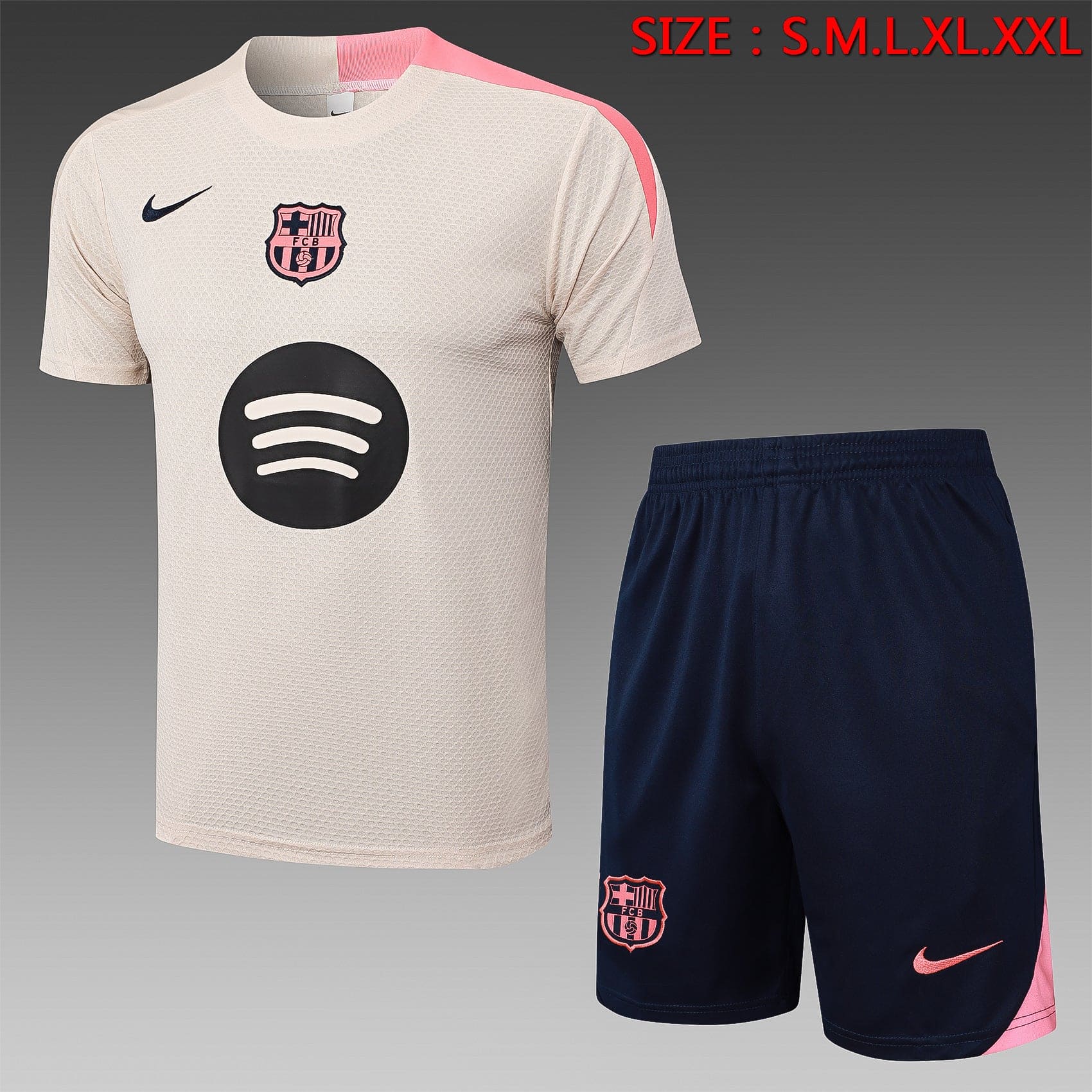 24e12209 | AE JERSEY Beige Barcelona football jersey with pink trim and sponsor logo, paired with navy shorts featuring the Barça crest and pink Nike swoosh.