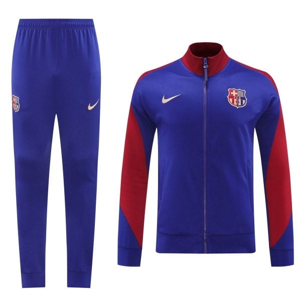 Royal blue FC Barcelona tracksuit jacket with red sleeves and crest, paired with matching blue pants and Nike swoosh logo on the thigh/hip area.