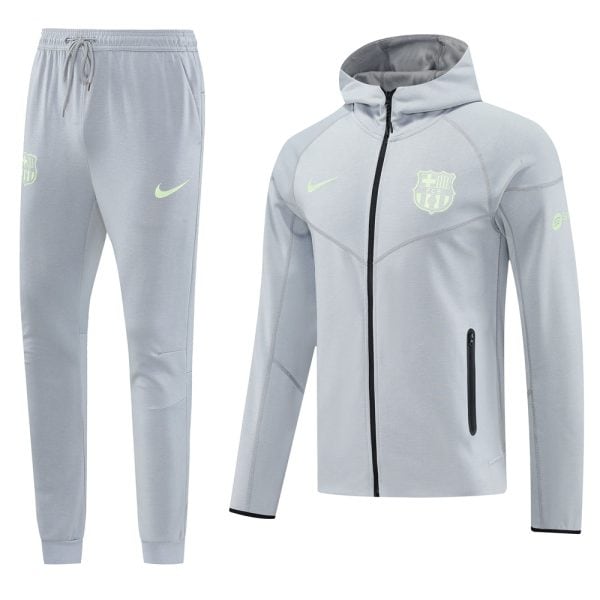 Light gray athletic tracksuit: hooded zip jacket and matching joggers with neon-green Nike swoosh and FC Barcelona crest.