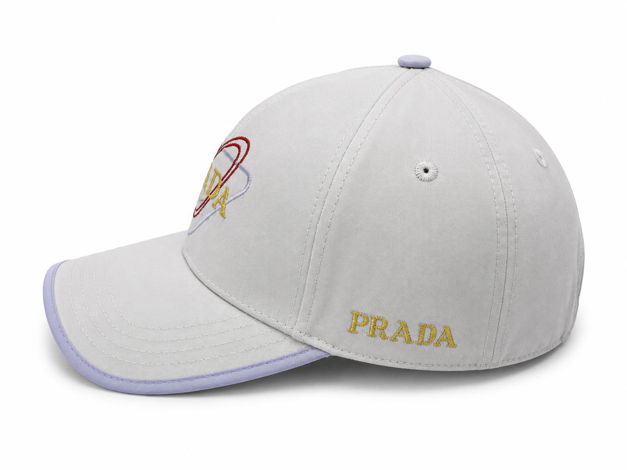 2cd33c92-d92f-4923-a1ba-1f8ffe2845d0 | AE JERSEY Light gray Prada baseball cap with a lavender brim and gold 'PRADA' embroidery on the front.