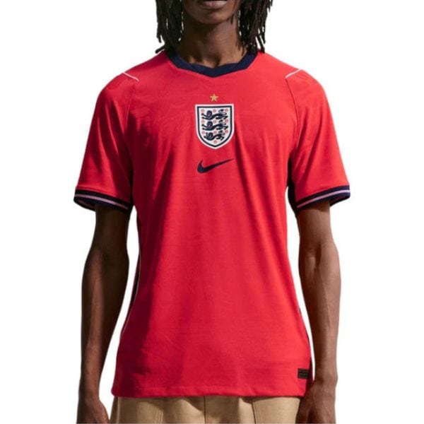 Red England national football team jersey with navy trim, crest featuring three lions and a star, and a Nike swoosh.