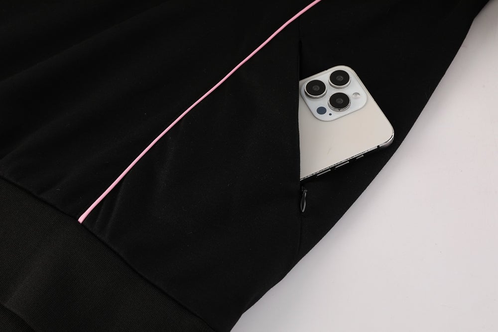 3c6f52fc | AE JERSEY Black hoodie with a pink drawstring; a smartphone peeks out from the pocket edge.