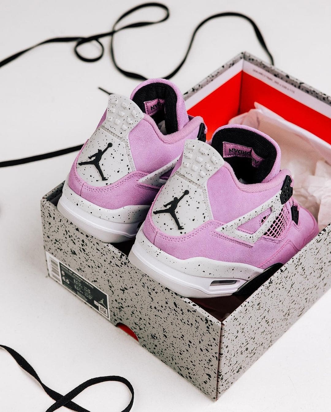 464566561_18379793389096448_2150568902365651684_n | AE JERSEY Pink Air Jordan sneakers in a speckled gray box, with Jumpman logo visible on the heel.