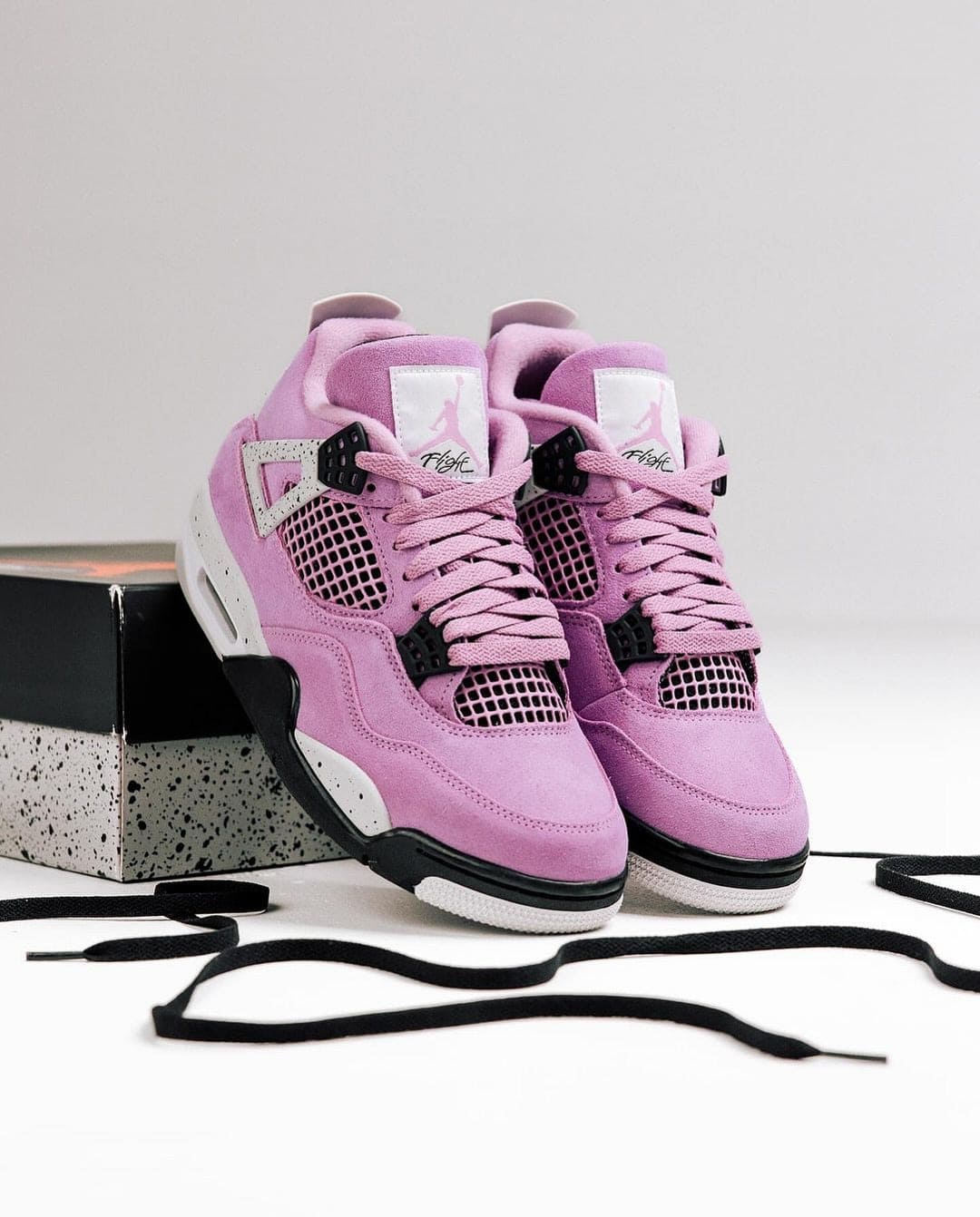 464757196_18379793380096448_4422407501248580978_n | AE JERSEY Pink suede high-top sneakers with black mesh panels and matching pink laces, resting beside a speckled shoebox.