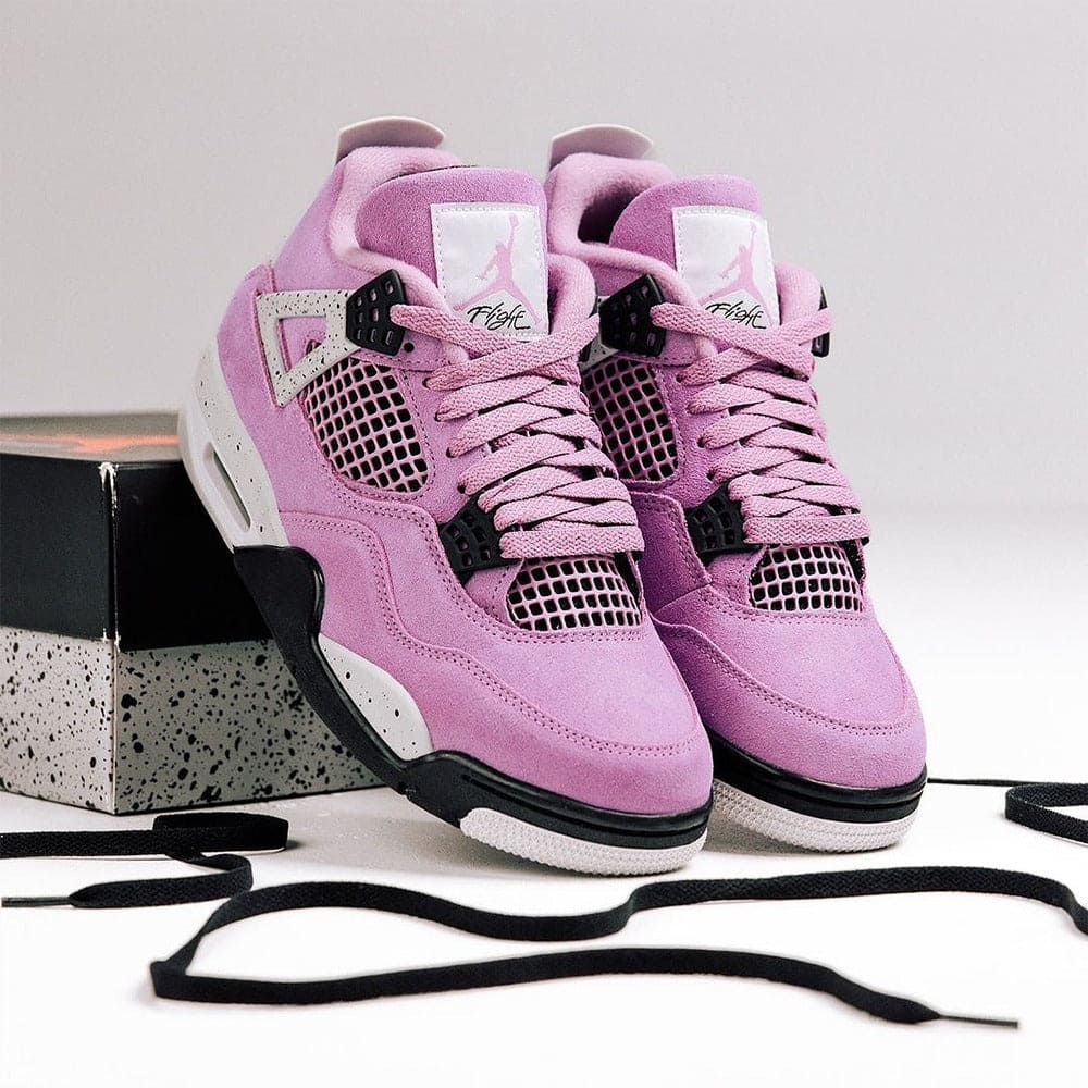 483942538_618673551071954_6853247878904373826_n | AE JERSEY Pair of pink purple high-top sneakers with black accents on a speckled box and loose black laces nearby