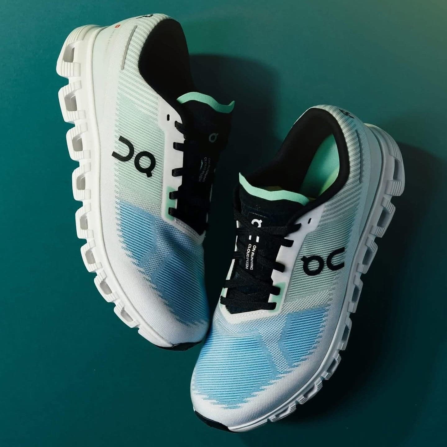 486577147_18356280661178405_845124594499007532_n | AE JERSEY White and light blue running shoes with chunky white soles on a teal background.