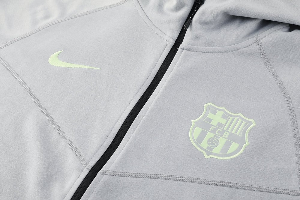 493da205 | AE JERSEY Gray zip-up athletic jacket with neon Nike swoosh and FC Barcelona crest on the chest area.