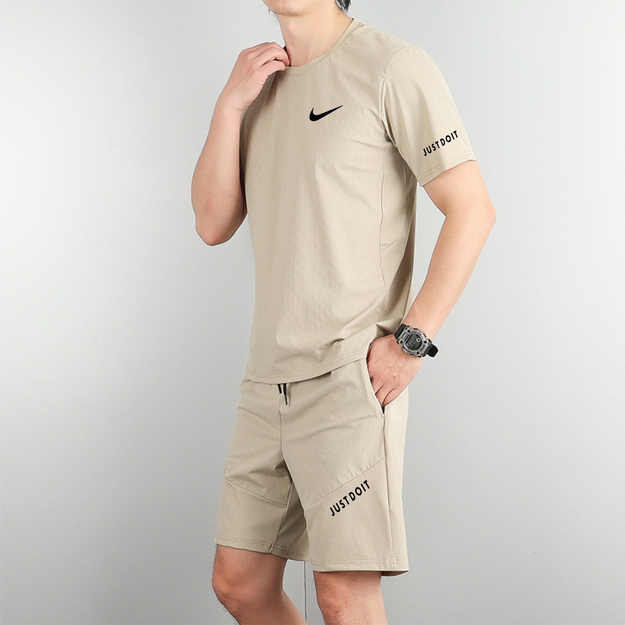 4bfdfa40 | AE JERSEY Person in beige athletic shirt and shorts, with a black Nike swoosh on the chest and 'JUST DO IT' on the leg area.
