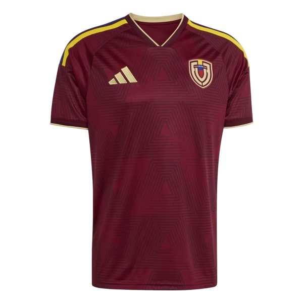 Maroon Adidas soccer jersey with gold crest on the chest and yellow shoulder stripes, geometric pattern throughout