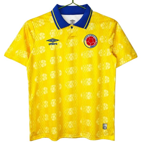 Yellow Colombia national football jersey with a blue collar, featuring the Umbro logo and the team crest on the chest.