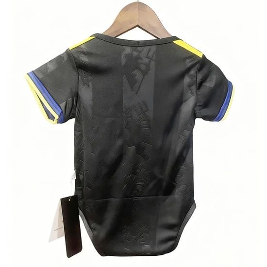 64aaf835-a9f2-4a69-b71e-ab323ae123b2 | AE JERSEY Back view of a black athletic jersey with yellow shoulder stripes and blue sleeve trim, hanging on a wooden hanger.