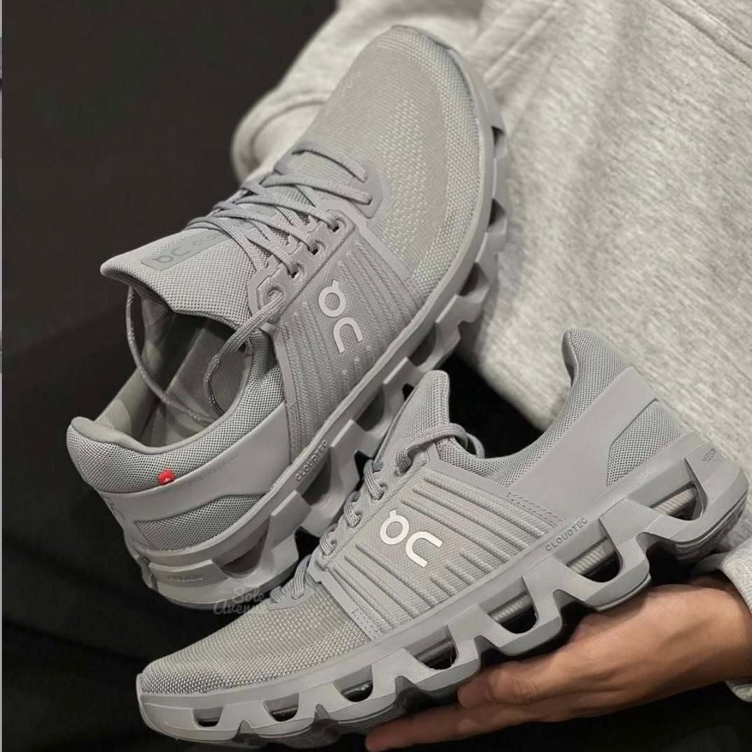 67d85645-be4a-4245-a354-59de82d55854 | AE JERSEY Gray On running shoes with a segmented, cloud-like sole and breathable mesh upper.