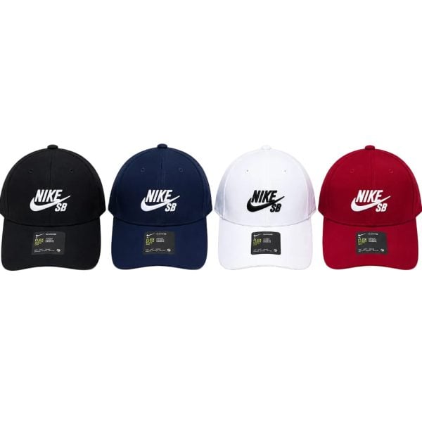 Lineup of four Nike SB baseball caps in black, navy, white, and red.