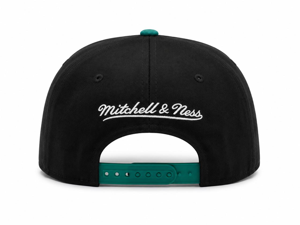 68ddce4b-41d7-4595-80da-01aa4d5edd18 | AE JERSEY Back view of a black Mitchell & Ness snapback cap with a teal plastic strap and white embroidered logo, curved brim unseen