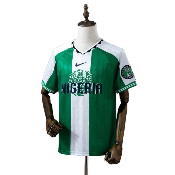 Nigeria national football team jersey on a dress form, green and white vertical stripes with crest and 'NIGERIA' text