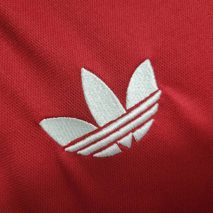 6cc9832fee6daf22_5dd7fb02-fa32-4d84-8911-3ca33d9251fa | AE JERSEY White Adidas trefoil logo on red fabric (close-up)