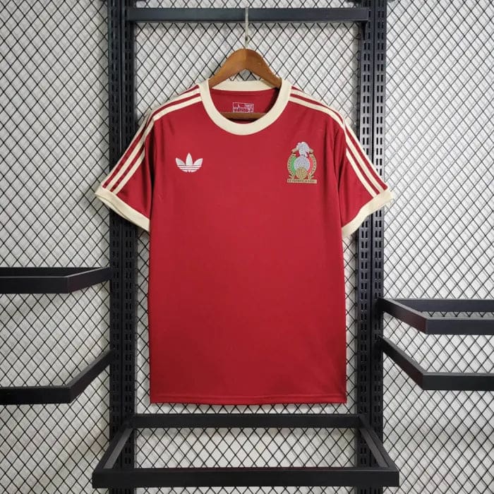 6dff0aaf06a93e62_5289fb3c-3bfa-41cd-97ad-18611b1efc64 | AE JERSEY Red Adidas soccer jersey on a hanger with cream collar and stripes, featuring a white trefoil logo and a Mexican crest on the chest.
