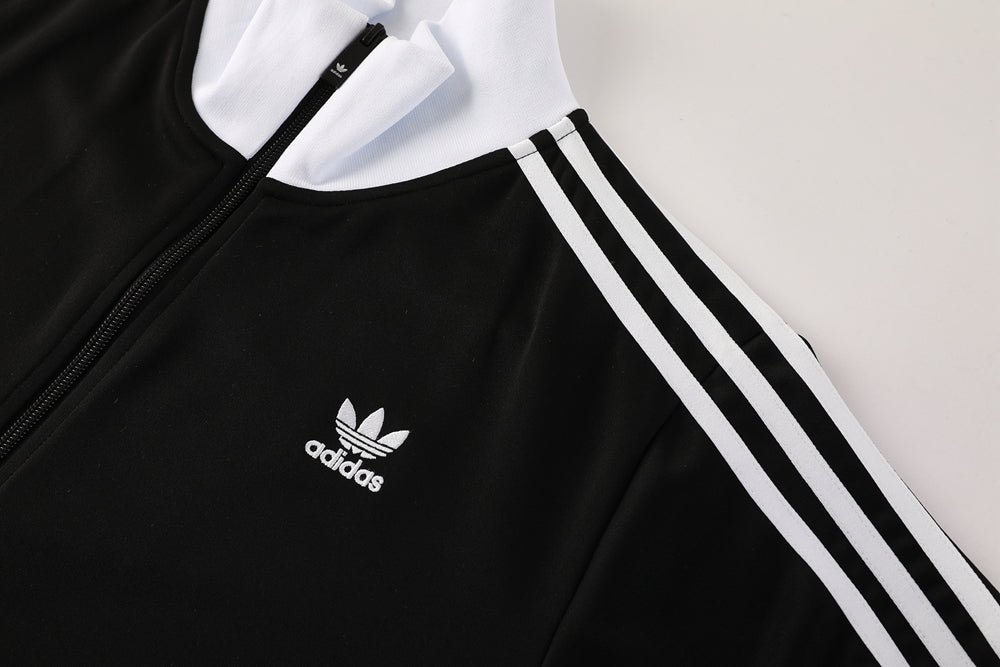 7008e69f | AE JERSEY Black Adidas track jacket with white piping and three stripes along the sleeve, front zipper, and small Adidas logo on the chest.