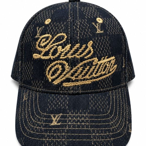 Dark denim baseball cap with gold embroidery reading Louis Vuitton on the front panel and brim stitching in gold thread