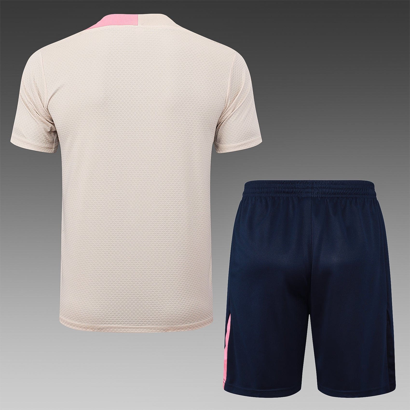 716140ce | AE JERSEY Back view of a beige textured athletic shirt paired with navy shorts featuring a pink stripe along the side.