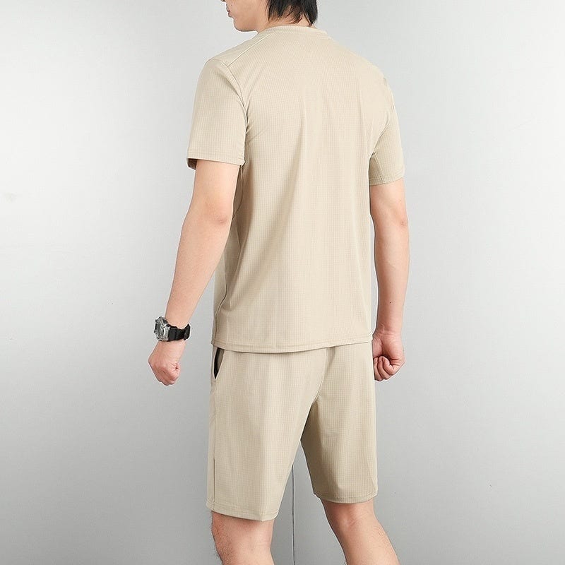 718e1a2f | AE JERSEY Man wearing a beige short-sleeve T-shirt and matching shorts, viewed from behind.