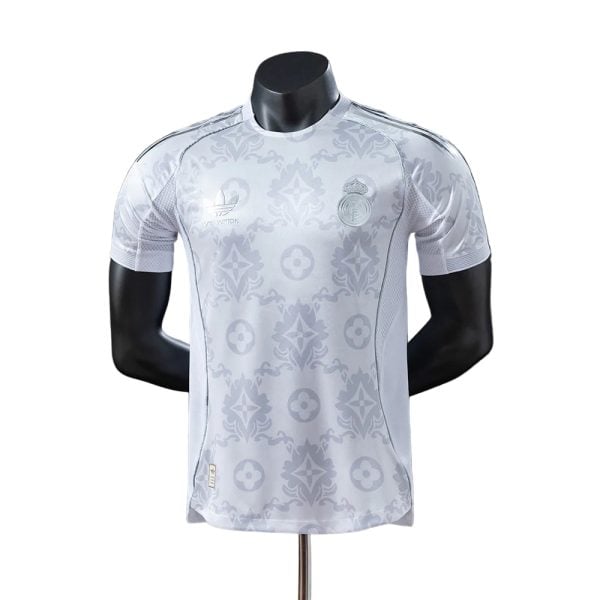 Light gray Real Madrid football jersey with Louis Vuitton monogram pattern on a display mannequin