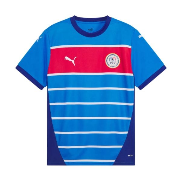 Blue soccer jersey with white horizontal stripes and a red chest band, featuring a circular federation crest on the left chest and Puma logos.