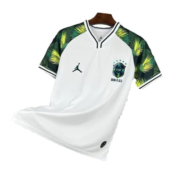 White Brazil national soccer jersey on a hanger, with green palm-pattern sleeves and team crest on the chest.