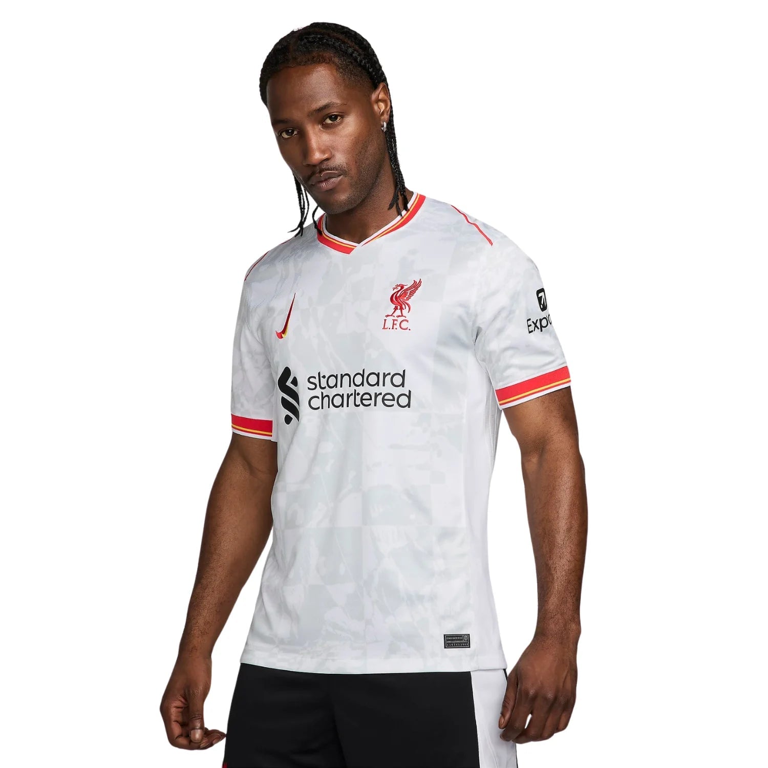 7_0b3de75e-9bf7-40e8-bc7b-c219c827ea33 | AE JERSEY Male model wearing Liverpool FC white away jersey with red trim, crest, Nike logo, and Standard Chartered sponsor.