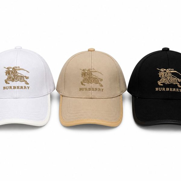 Three Burberry baseball caps in white, tan, and black with gold embroidered equestrian logo and 'BURBERRY' text (front view).