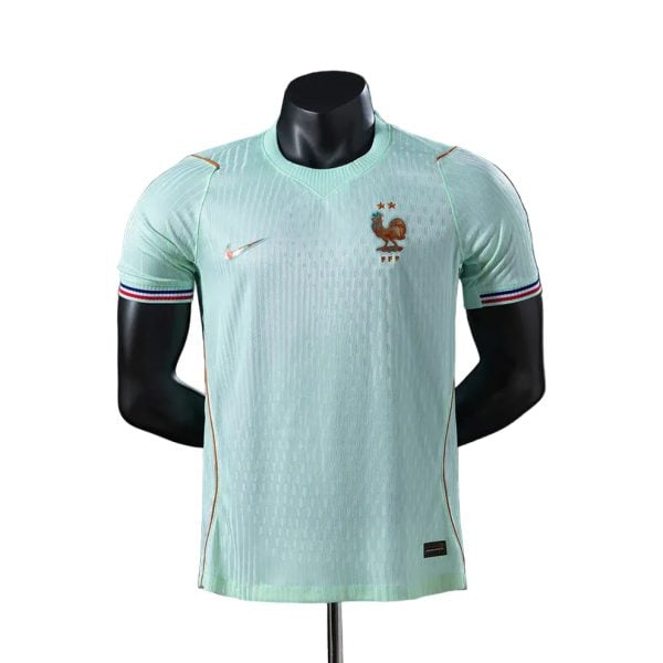 France national team away soccer jersey on a display mannequin, light mint green with rooster badge and Nike swoosh