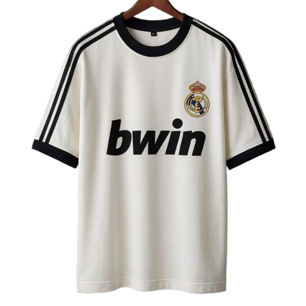 White Real Madrid football jersey on a hanger with black trim, Real Madrid crest, and 'bwin' sponsor.